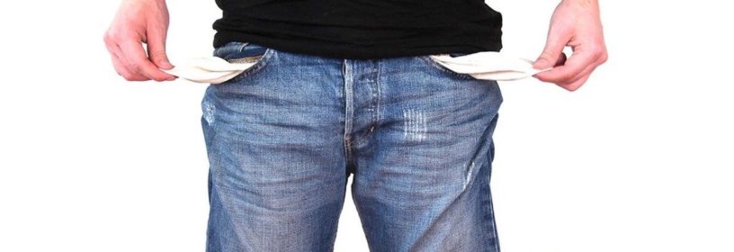 man pulling empty pockets out of shorts