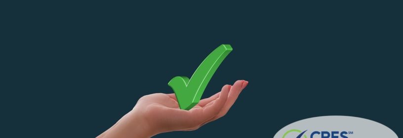 woman's hand holding up a green checkmark