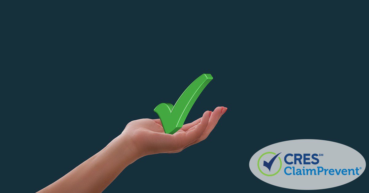 woman's hand holding up a green checkmark