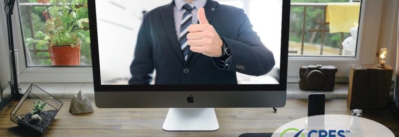 home office with a computer screen image of man giving thumbs up