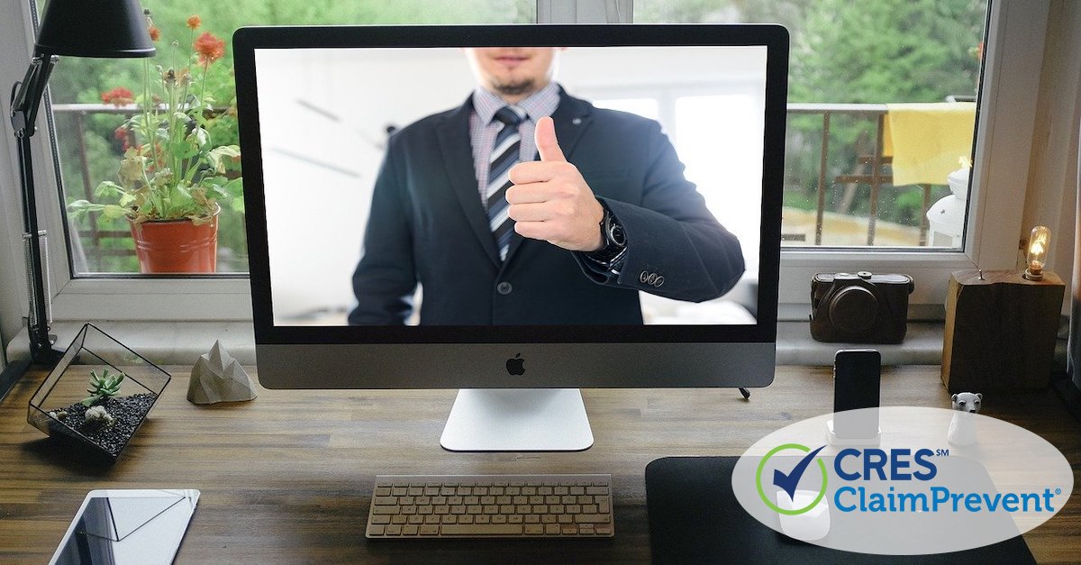 home office with a computer screen image of man giving thumbs up