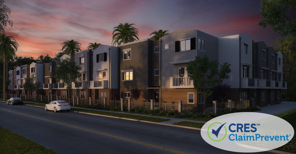 condo complex with palm trees and sunset