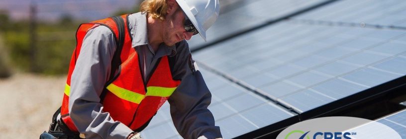 man fixing broken solar panel on house