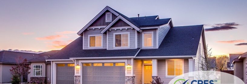Two story house in neighborhood with sunset