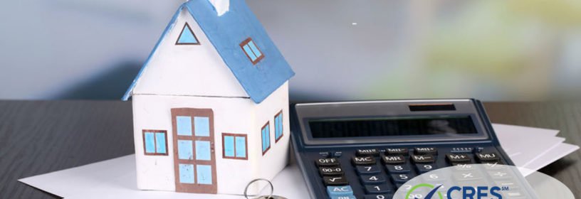 toy house and calculator on table close-up