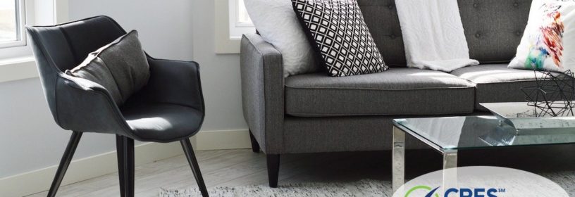 living room staged with gray and black chair and couch