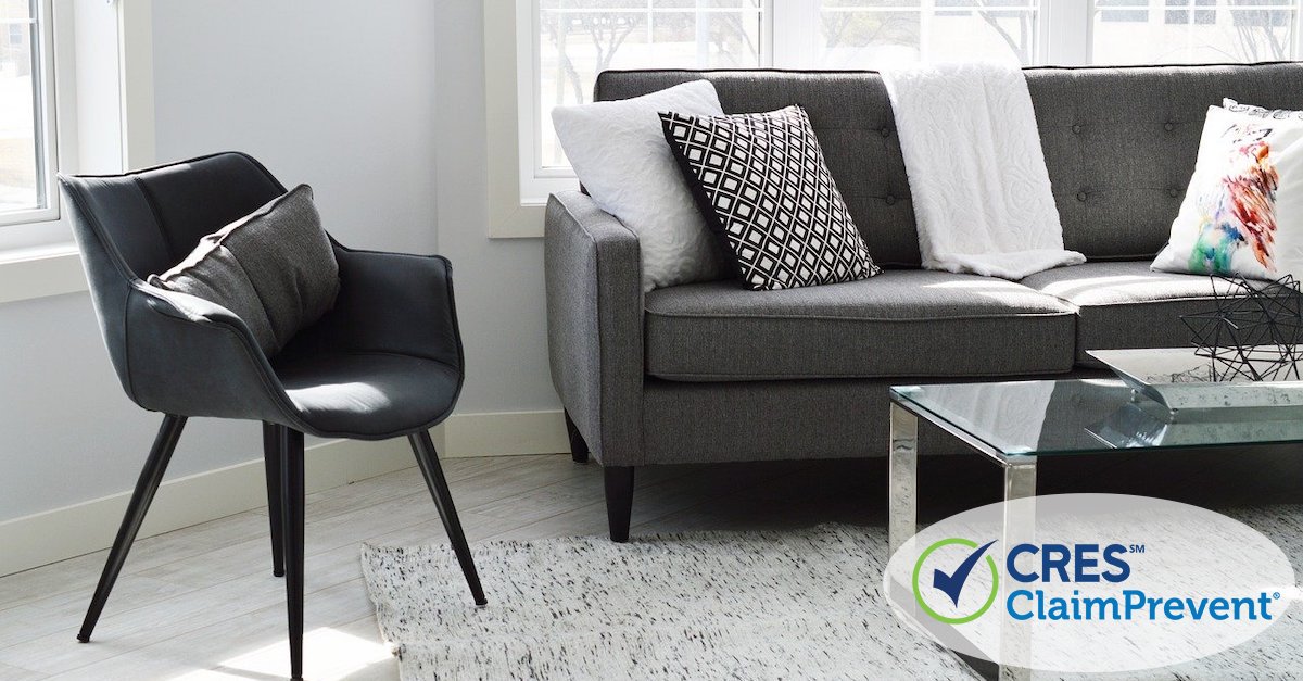 living room staged with gray and black chair and couch