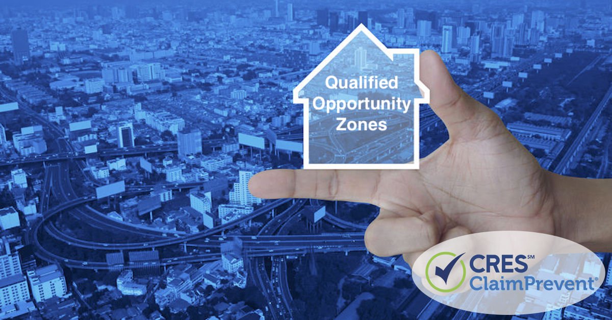 hand holding house concept image with qualified opportunity zones text overlaid on a cityscape