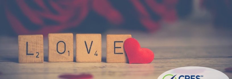 scrabble blocks that spell love with a red heart next to it