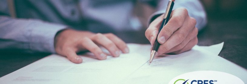 man filling out application paperwork at a desk