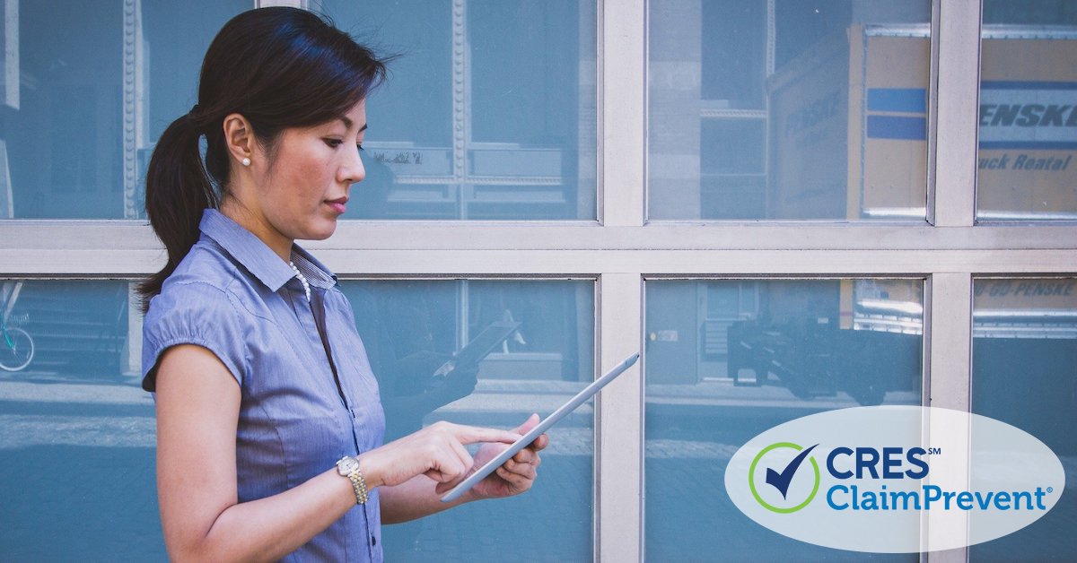 woman standing outside in front of building on ipad