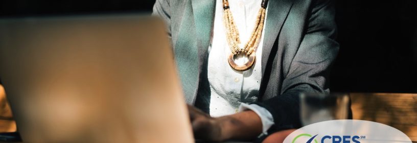 woman sitting at laptop doing work
