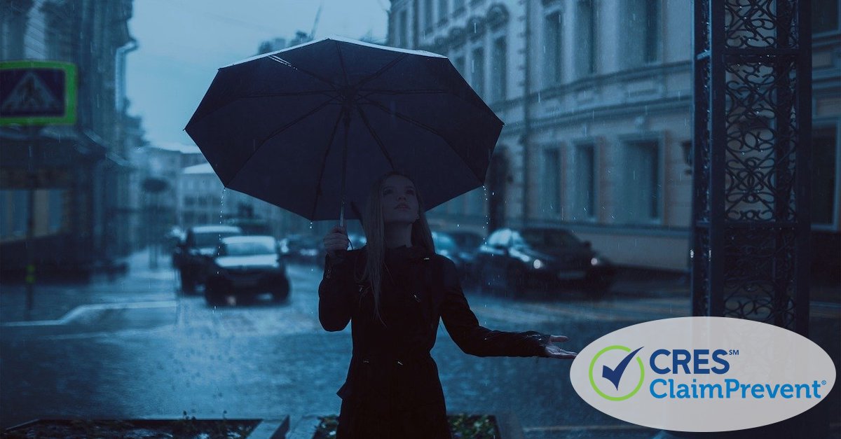 woman on street with umbrella in the rain