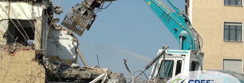 blue crane knocking down building