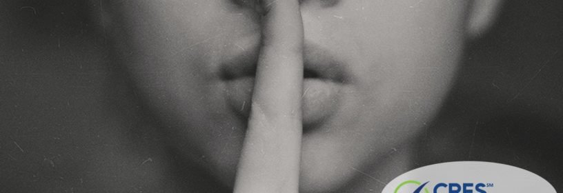 image of woman with her index finger in front of her lips