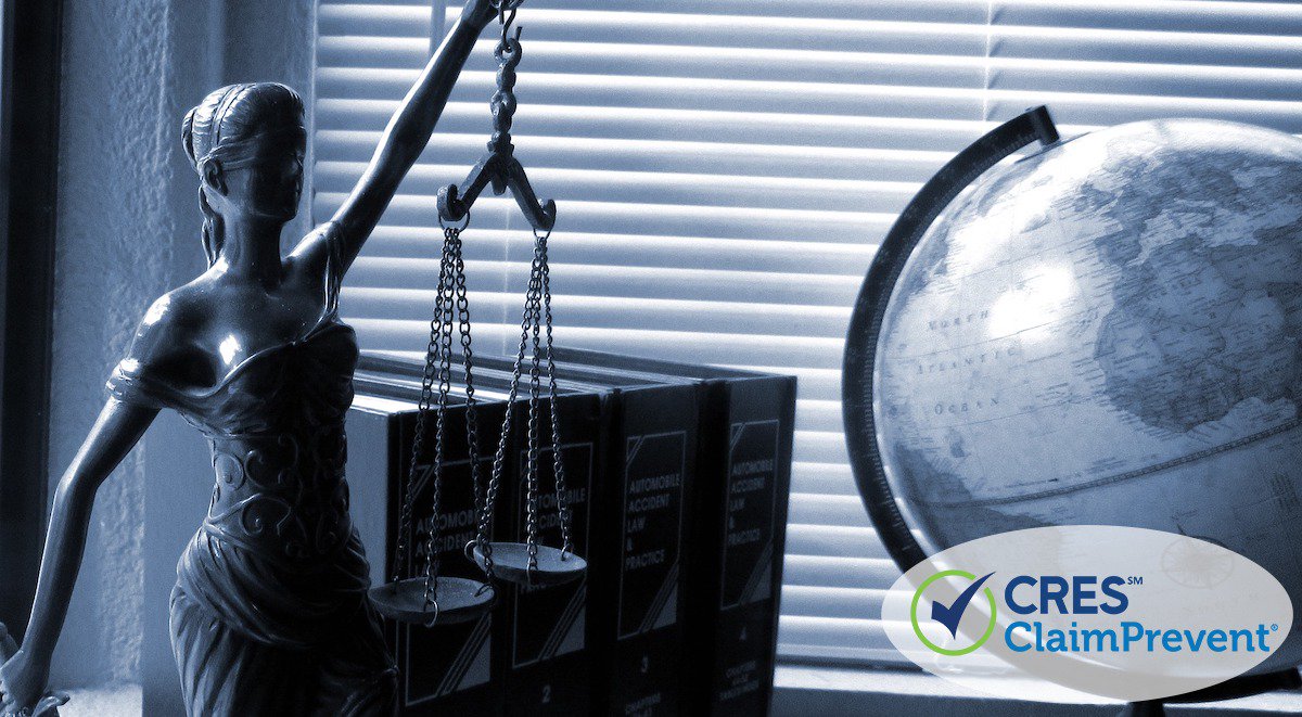 status on desk of lady justice holding scales