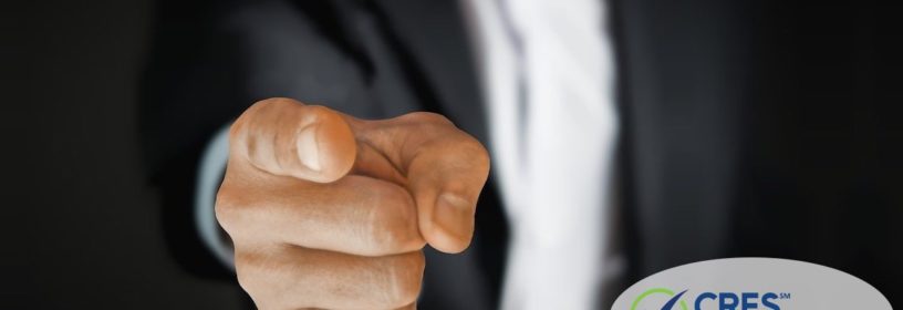 man in suit pointing at camera