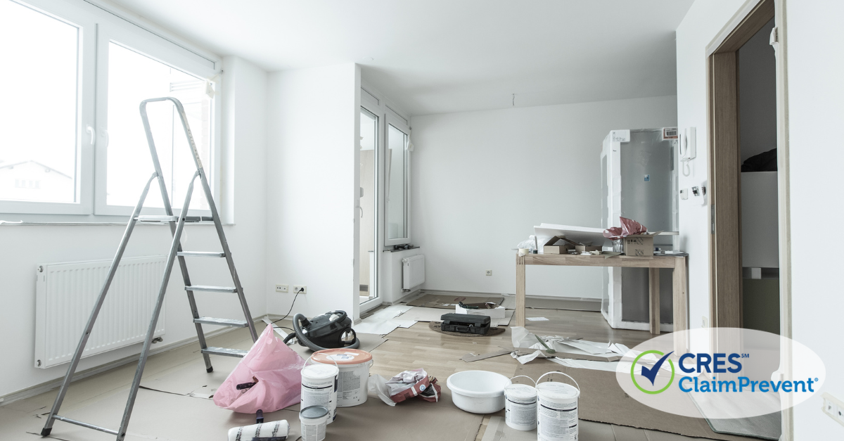 an apartment being painted with paint cans everywhere