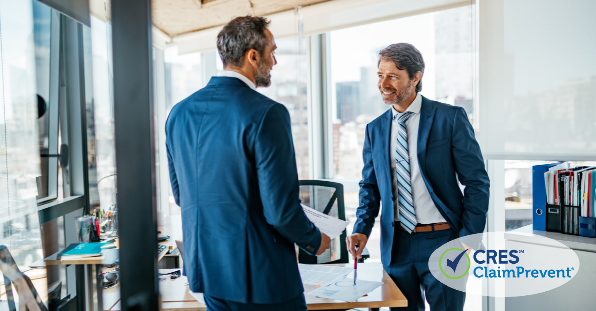 men wearing suits in office talking