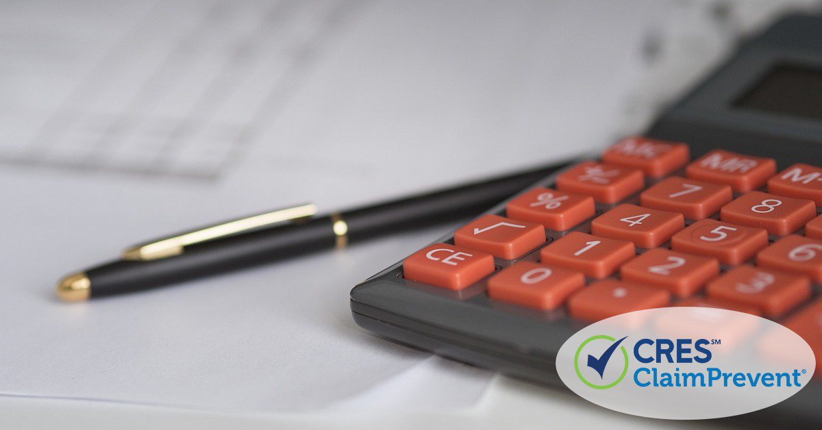 calculator and pen sitting on top of paperwork