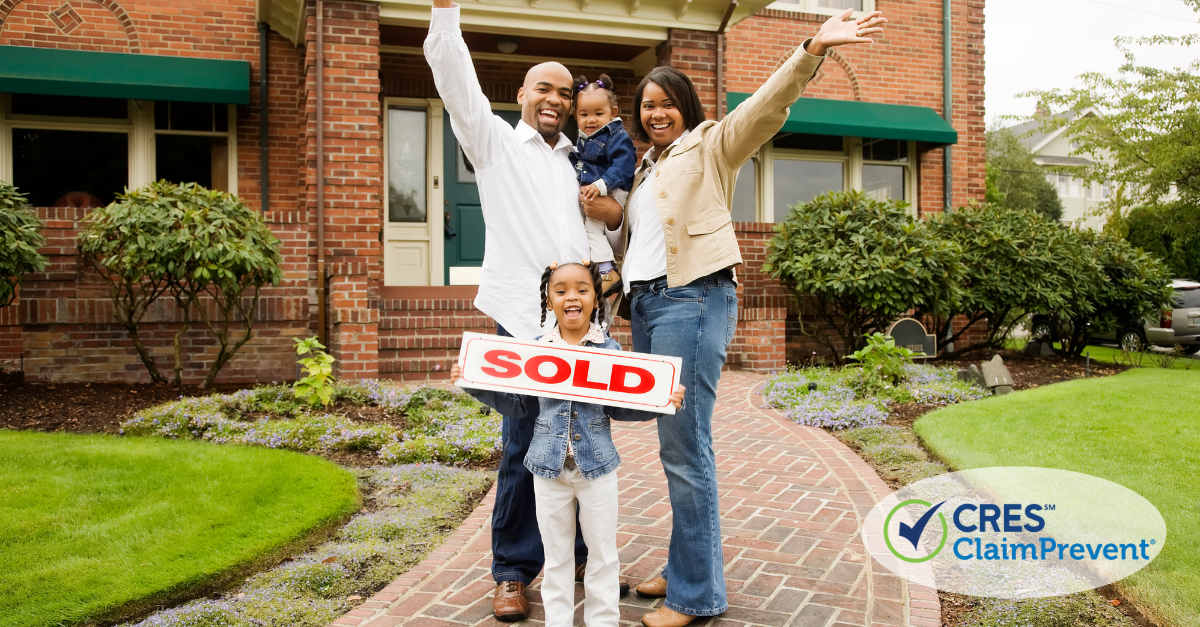 family in front of home with sold sign
