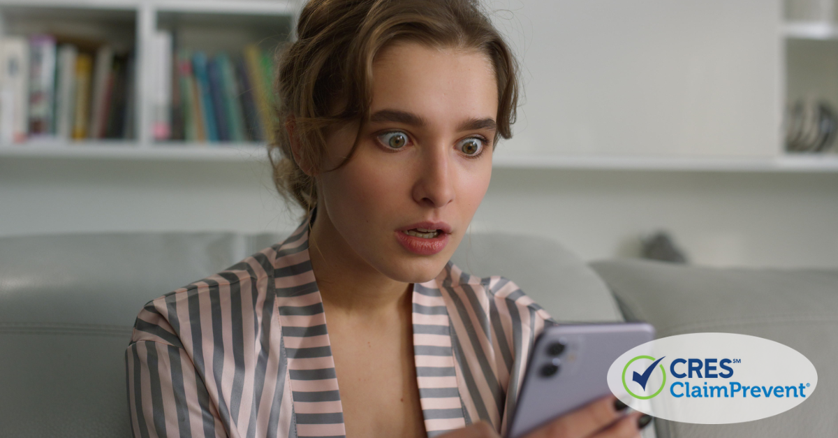 woman looking at phone with shocked expression