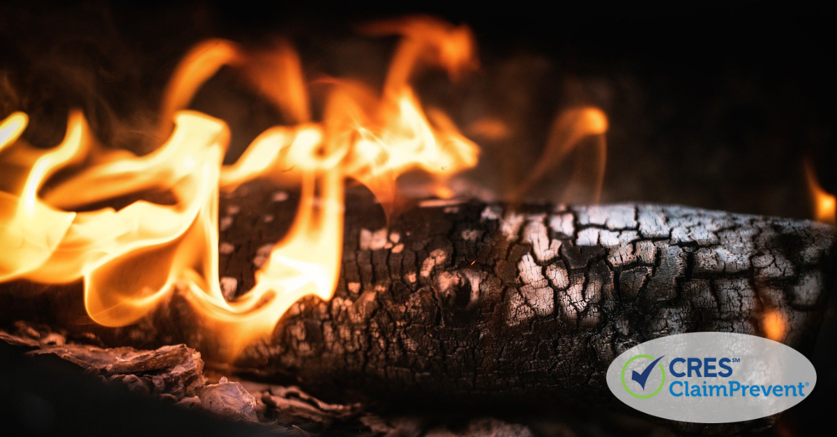 ashed log on fire with bright orange flames